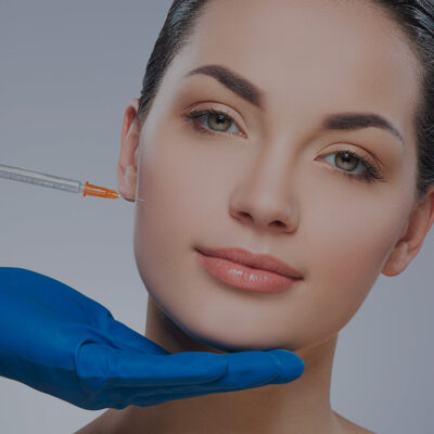 A woman is getting orthodontics treatment with braces on her face.